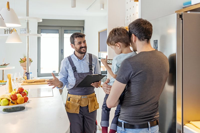 HVAC technician discussing homeowner's options for air conditioning service.