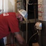 Greens Heating and AC technician installing a heating system.