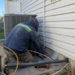 Greens Heating and AC technician installing a concrete pad for a heat pump.