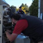 HVAC technician inspecting new Lennox furnace before installation at residential home in Nampa.