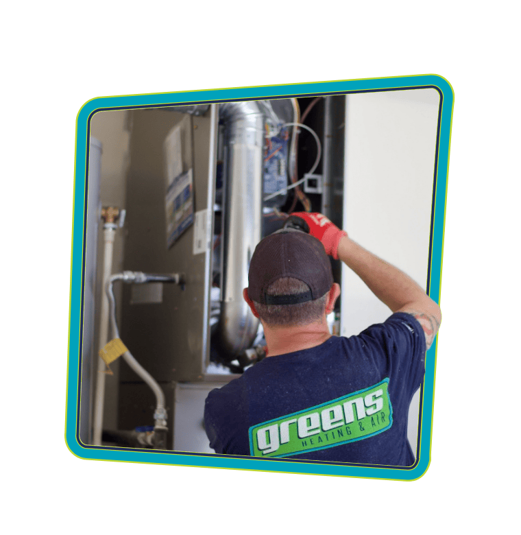 Greens' technician repairing a furnace during a heating service call in Boise, Idaho.